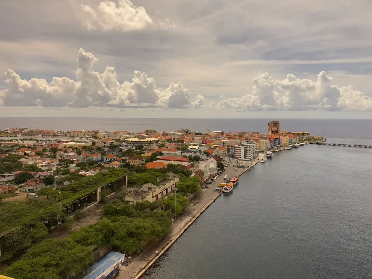 Curacao waterfront promenade with historic buildings and palm trees lining the harbor
